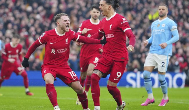 Liverpool&#x27;s Alexis Mac Allister, left, celebrates after scoring a penalty, his side&#x27;s first goal during the English Premier League soccer match between Liverpool and Manchester City, at Anfield stadium in Liverpool, England, Sunday, March 10, 2024. (AP Photo/Jon Super)