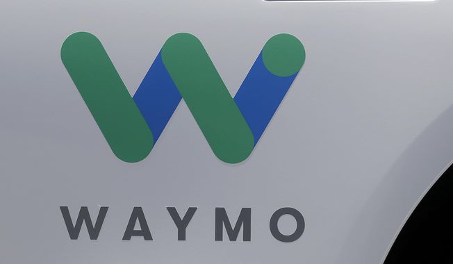 In this May 8, 2018, file photo, a Waymo logo is displayed on the door of a car at the Google I/O conference in Mountain View, Calif. Robotaxis are hitting the streets of Los Angeles. Google spinoff Waymo says on Thursday, March 14, 2024, it will begin offering free rides to some of the roughly 50,000 people who have signed up for its driverless ride-hailing service in the second largest U.S. city. (AP Photo/Jeff Chiu, File)