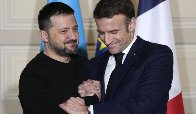 Ukrainian President Volodymyr Zelenskyy, left, and French President Emmanuel Macron shake hands after a press conference, on Feb. 16, 2024, at the Elysee Palace in Paris. (AP Photo/Thibault Camus, Pool) **FILE**