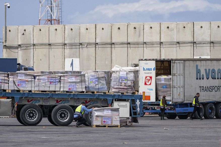 Trucks carrying humanitarian aid for the Gaza Strip pass through the inspection area at the Kerem Shalom Crossing in southern Israel, Thursday, March 14, 2024. (AP Photo/Ohad Zwigenberg) ** FILE **