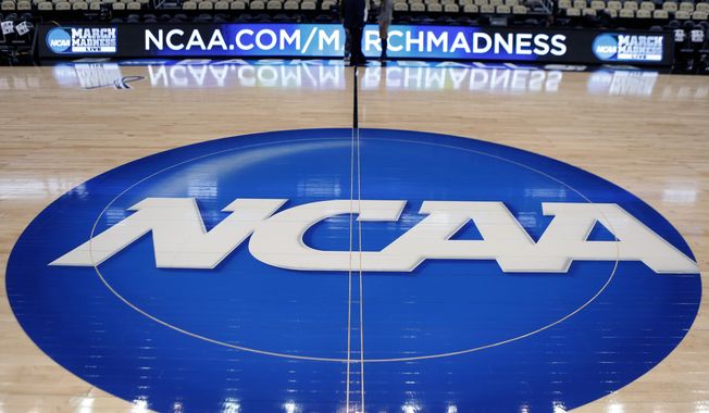 In this March 18, 2015, file photo, the NCAA logo is displayed at center court at The Consol Energy Center in Pittsburgh. More than half of Americans say they are against college athletes unionizing, though younger respondents were more supportive than older, according to a new poll from The Associated Press-NORC Center for Public Affairs Research. (AP Photo/Keith Srakocic, File)