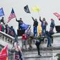 Rioters wave flags on the West Front of the U.S. Capitol in Washington on Jan. 6, 2021. (AP Photo/Jose Luis Magana, File)