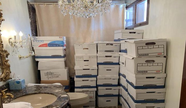 This image, contained in the indictment against former President Donald Trump, shows boxes of records stored in a bathroom and shower in the Lake Room at Trump&#x27;s Mar-a-Lago estate in Palm Beach, Fla. A federal judge is set to hear arguments on whether to dismiss the classified documents prosecution of Donald Trump. His lawyers say the former president was entitled under the Presidential Records Act to keep the sensitive documents with him when he left the White House and headed to Florida. (Justice Department via AP)