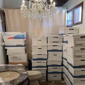 This image, contained in the indictment against former President Donald Trump, shows boxes of records stored in a bathroom and shower in the Lake Room at Trump&#x27;s Mar-a-Lago estate in Palm Beach, Fla. A federal judge is set to hear arguments on whether to dismiss the classified documents prosecution of Donald Trump. His lawyers say the former president was entitled under the Presidential Records Act to keep the sensitive documents with him when he left the White House and headed to Florida. (Justice Department via AP)