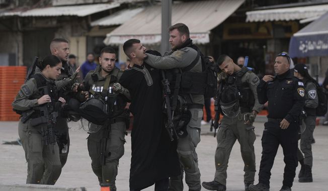 Israeli security forces detain a Palestinian man during the Muslim holy month of Ramadan just outside Jerusalem&#x27;s Old City, Friday, March 15, 2024. (AP Photo/Maya Alleruzzo)