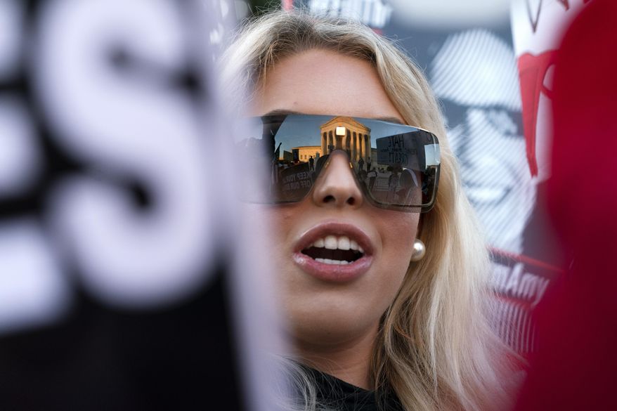Isabella DeLuca, of Long Island, N.Y., appears outside the Supreme Court, Oct. 26, 2020, on Capitol Hill in Washington. DeLuca, a conservative social media influencer, has been charged with storming the U.S. Capitol. Court records unsealed Monday, March 18, 2024, show that DeLuca is charged with misdemeanors, including theft of government property, disorderly conduct and entering a restricted area. She was arrested last Friday in Irvine, Calif. (AP Photo/Jacquelyn Martin, File)