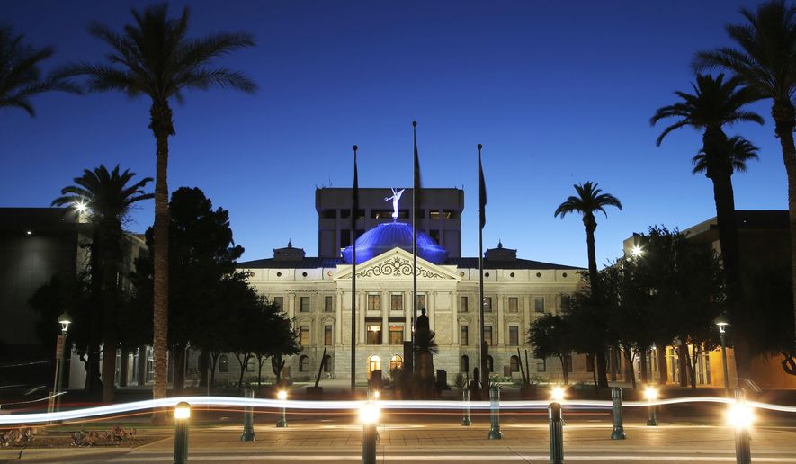FILE - The blur of car lights zip past the Arizona Capitol as the dome is illuminated on April 15, 2020, in Phoenix. An Arizona lawmaker announced on the state Senate floor Monday, March 18, 2024, that she plans to have an abortion after learning that her pregnancy is not viable. (AP Photo/Ross D. Franklin, File)