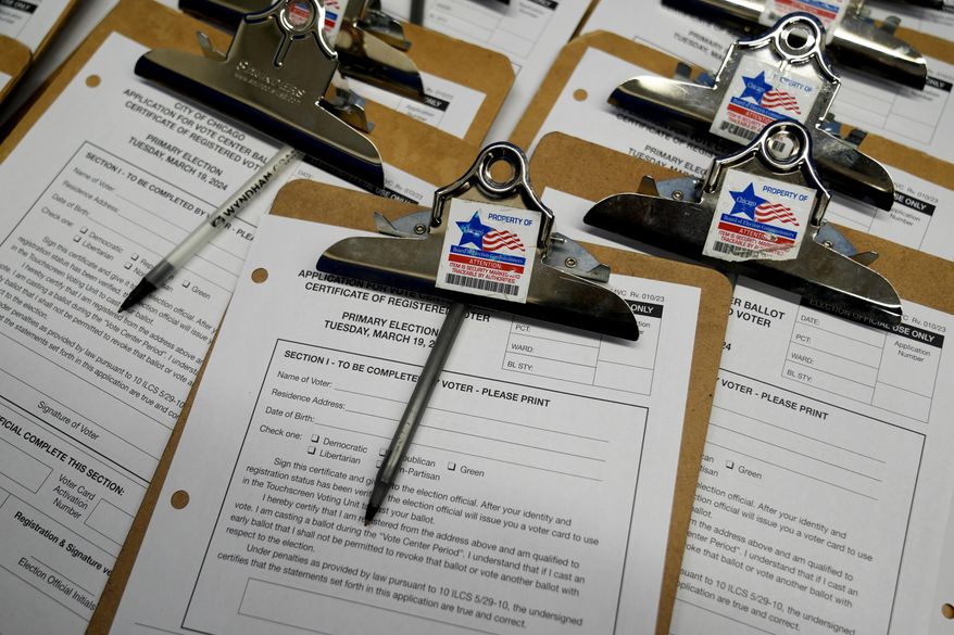 Voter registration forms are sit on the table for voters at Chicago Loop Super Site in Chicago, Tuesday, March 19, 2024. Illinois residents will vote Tuesday to narrow Democratic and GOP candidate fields in key U.S. House races. (AP Photo/Nam Y. Huh)