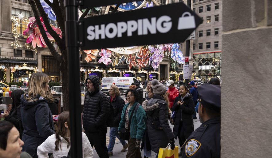 Shoppers and sightseers walk along 5th Avenue, Dec. 11, 2023, in New York. The National Retail Federation said Wednesday, March 20, 2024, that retail sales will increase anywhere between 2.5% and 3.5% this year, a solid but still slower pace than the 3.6% seen last year. (AP Photo/Yuki Iwamura, File)