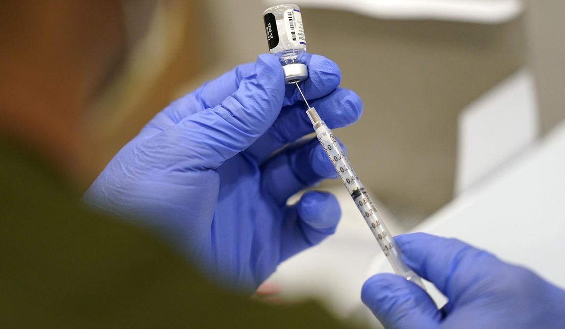A healthcare worker fills a syringe with the Pfizer COVID-19 vaccine at Jackson Memorial Hospital, Oct. 5, 2021, in Miami. Three years after COVID-19 vaccines became widely available in the United States, Louisiana continues to debate policies related to inoculation mandates, including civil labilities if a work place mandates vaccines or not and a bill that would prohibit schools from requiring students to receive the vaccine. (AP Photo/Lynne Sladky, File)