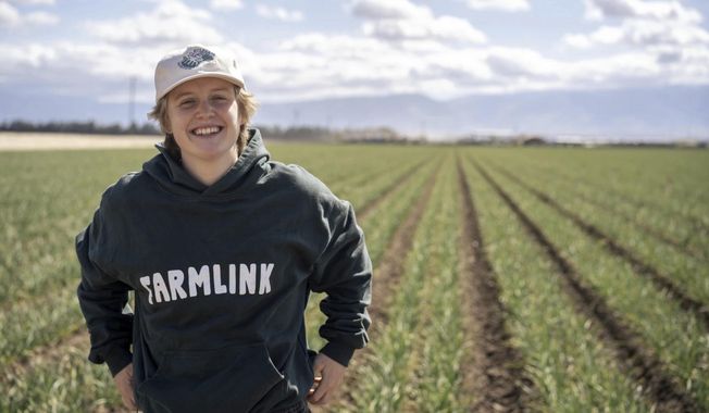 This 2022 photo shows Kate Nelson in Bakersfield, Calif,, after attending a Farmlink Project food delivery in Bakersfield to support the farmer community. Farmlink Project is one of numerous nonprofits established by Gen Z founders during the COVID-19 pandemic. (Owen Dubeck/Farmlink Project via AP)