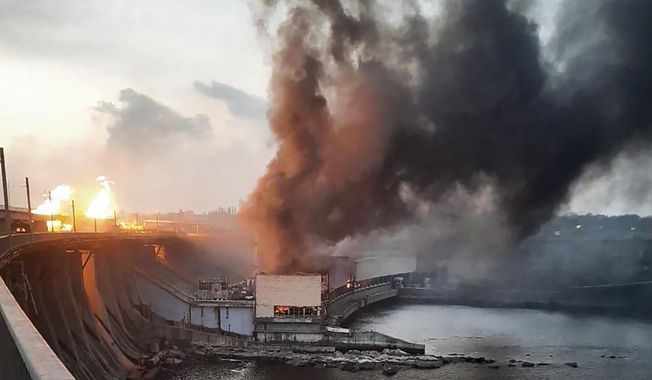 In this photo provided by Telegram Channel of Ukraine&#x27;s Prime Minister Denys Shmyhal, smoke and fire rise over the Dnipro hydroelectric power plant after Russian attacks in Dnipro, Ukraine, Friday, March 22, 2024. (Telegram Channel of Ukraine&#x27;s Prime Minister Denys Shmyhal via AP)