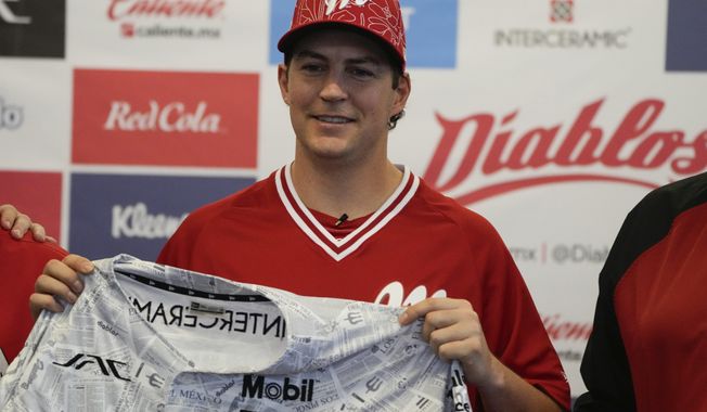 Trevor Bauer attends his introduction ceremony as Diablos de Mexico&#x27;s new starting pitcher at Alfredo Harp Helú stadium in Mexico City, Friday, March 22, 2024. (AP Photo/Fernando Llano)