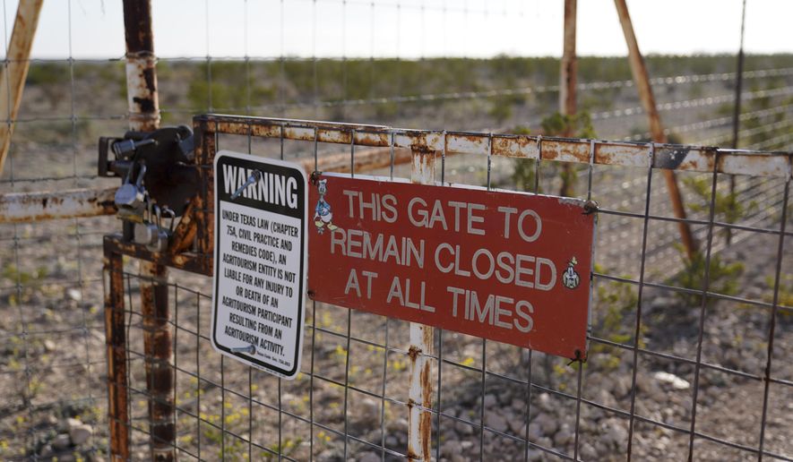 A gate leading to Bone Water Crossing on the Rio Grande River is seen, Thursday, March 21, 2024, in Terrell County, Texas. (AP Photo/Erik Verduzco)