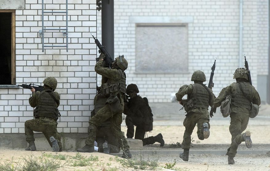 Soldiers of the NATO enhanced forward presence battalion take part in a military exercise 'Saber Strike 2018' at the Training Range in Pabrade some 38 miles north of the capital Vilnius, Lithuania, June 11, 2018. The U.S. Congress has passed a bill that involves a total of $228 million in military and defense aid to Estonia, Latvia and Lithuania this year under the Baltic Security Initiative, Estonia’s defense officials said Saturday March 23, 2024. (AP Photo/Mindaugas Kulbis, File)