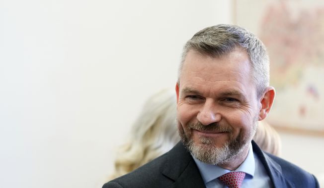 Presidential candidate Peter Pellegrini, who currently serves as Parliament&#x27;s speaker, smiles before casting his vote during the first round of the presidential election in Bratislava, Slovakia, Saturday, March 23, 2024. (AP Photo/Petr David Josek)
