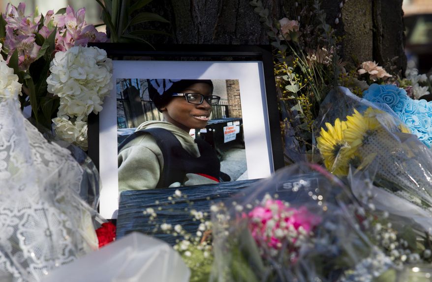 A photo of Jayden Perkins, a 11-year-old boy who was stabbed to death in his home on March 13, at a memorial on March 15, 2024, outside Perkin's home in Chicago. A state parole board member resigned Monday, March 25 after recommending the release of a man who a day later attacked a pregnant Chicago woman with a knife and fatally stabbed her son while he tried to protect her, according to authorities. (Vincent Alban/Chicago Tribune via AP)