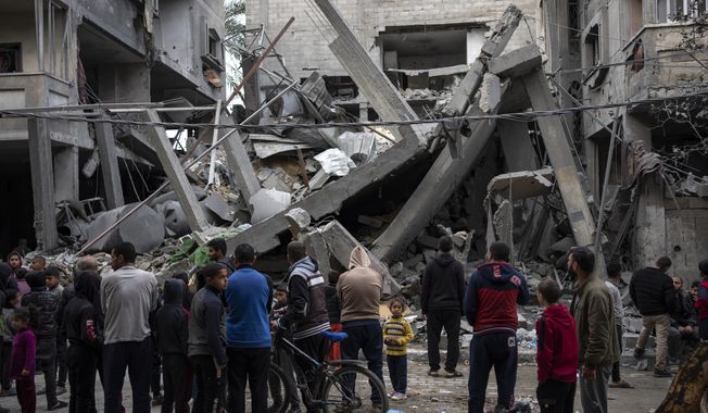 Palestinians inspect the damage of residential buildings after an Israeli airstrike in Rafah, southern Gaza Strip, Sunday, March 24, 2024. (AP Photo/Fatima Shbair)