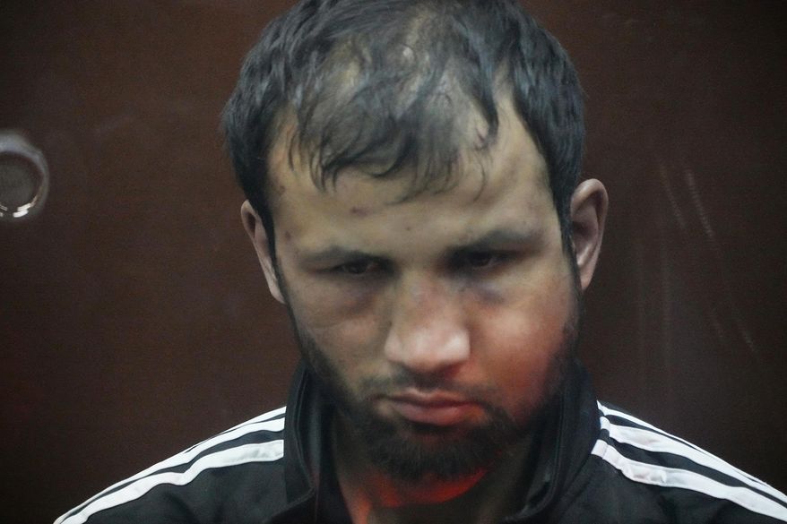 Shamsidin Fariduni, a suspect in the Crocus City Hall shooting on Friday sits in a glass cage in the Basmanny District Court in Moscow, Russia, Sunday, March 24, 2024. The four men charged with the massacre at a Moscow theater have been identified by the Russian government as citizens of Tajikistan, some of the thousands who migrate each year from the poorest of the former Soviet republics to scrape out marginal existences. (AP Photo/Alexander Zemlianichenko)
