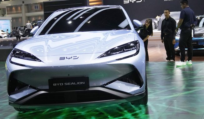 Visitors look at BYD&#x27;s electric vehicle &quot;Sealion&quot; during the 45th Bangkok Motor Show in Nonthaburi , Tuesday, March 26, 2024. Thailand. (AP Photo/Sakchai Lalit)