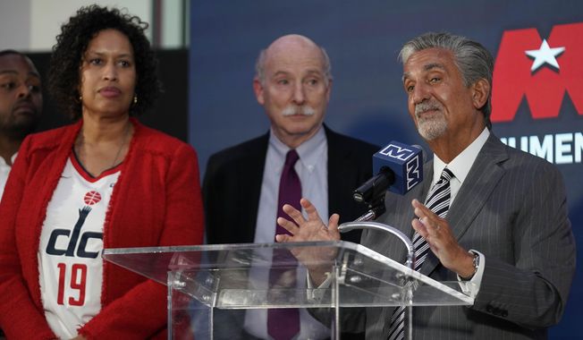 Ted Leonsis, right, owner of the Washington Wizards NBA basketball team and Washington Capitals NHL hockey team, speaks during a news conference with Washington DC Mayor Muriel Bowser, left, and DC Council Chairman Phil Mendelson, center, at Capitol One Arena in Washington, Wednesday, March 27, 2024. (AP Photo/Stephanie Scarbrough)