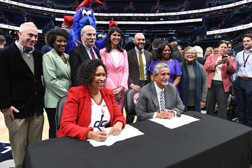 Monumental Sports & Entertainment chief executive Ted Leonsis and D.C. Mayor Muriel E. Bowser about to sign an agreement that would keep the Wizards and Capitals at Capital One Arena in Washington D.C. until 2050, March 27, 2024. (Photo by Jack Sabatini)