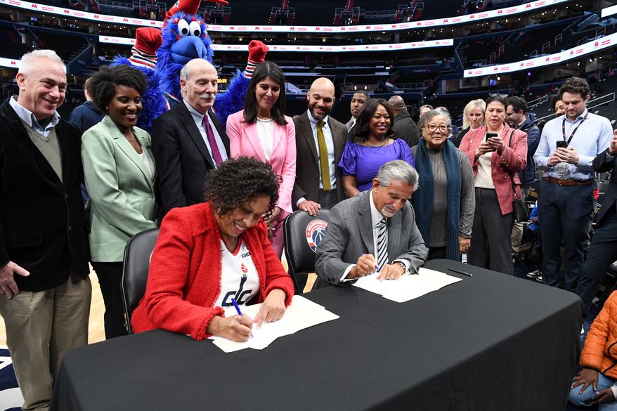 Monumental Sports & Entertainment chief executive Ted Leonsis and D.C. Mayor Muriel E. Bowser signing an agreement that would keep the Wizards and Capitals at Capital One Arena in Washington D.C. until 2050, March 27, 2024. (Photo by Jack Sabatini)