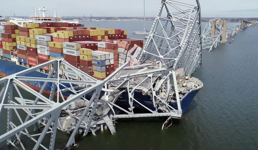In this image taken from video released by the National Transportation and Safety Board, the cargo ship Dali is stuck under part of the structure of the Francis Scott Key Bridge after the ship hit the bridge, Tuesday, March 26, 2024, in Baltimore. (NTSB via AP)