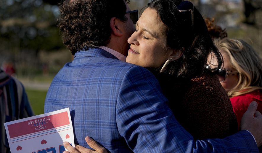 Katy Dieckhaus, right, mother of Evelyn Dieckhaus a victim in the Covenant School shooting receives a hug after the Linking Arms for Change human chain Wednesday, March 27, 2024, in Nashville, Tenn. The event was to commemorate the one-year anniversary of the incident where three students and three adults were killed by a shooter. (AP Photo/George Walker IV)