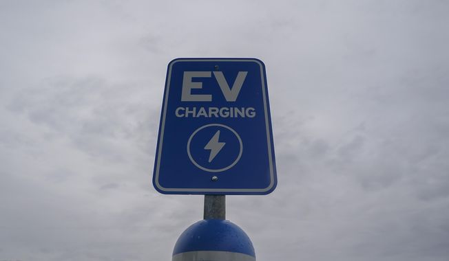 A sign sits at an electric vehicle charging station, Friday, March 8, 2024, at an electric vehicle charging station in London, Ohio. The charging ports are a key part of President Joe Biden’s effort to encourage drivers to move away from gasoline-powered cars and trucks that contribute to global warming. (AP Photo/Joshua A. Bickel) ** FILE **