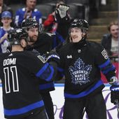 Toronto Maple Leafs left wing Tyler Bertuzzi (59) celebrates his goal against the Washington Capitals with forward Max Domi (11) and defenseman TJ Brodie (78) during the second period of an NHL hockey game Thursday, March 28, 2024, in Toronto. (Nathan Denette/The Canadian Press via AP)