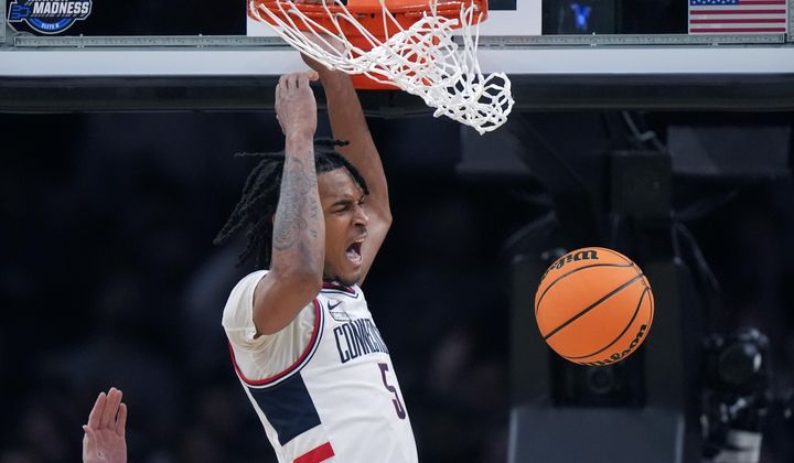 UConn guard Stephon Castle (5) roars while dunking against San Diego State during the second half of the Sweet 16 college basketball game in the men&#x27;s NCAA Tournament, Thursday, March 28, 2024, in Boston. (AP Photo/Steven Senne)