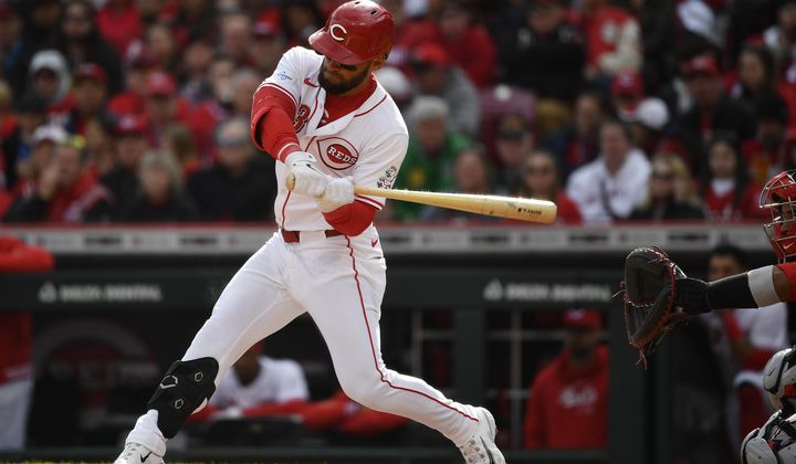 Cincinnati Reds&#x27; Nick Martini (23) takes a swing during the second inning of an opening day baseball game against the Washington Nationals in Cincinnati, Thursday, March 28, 2024. (AP Photo/Timothy D. Easley)