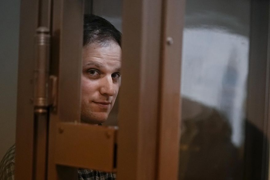 Wall Street Journal reporter Evan Gershkovich stands in a defendants’ cage for a hearing in Moscow, Russia, on April 18, 2023. The 32-year-old U.S. citizen was arrested in late March 2023 and accused of espionage, charges that he, his employer and the U.S. government all deny. (AP Photo/Alexander Zemlianichenko, File)