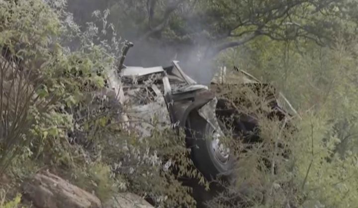 In this image taken from video provided by eNCA, a bus carrying worshippers headed to an Easter festival plunged off a bridge on a mountain pass and burst into flames in Limpopo, South Africa, on Thursday, March 28, 2024, killing multiple people, authorities said. (eNCA via AP)