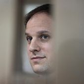 Wall Street Journal reporter Evan Gershkovich stands in a glass cage in a courtroom at the Moscow City Court in Moscow, Russia, Oct. 10, 2023. (AP Photo/Alexander Zemlianichenko, File)