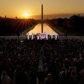 FILE - The word &quot;Jesus&quot; is displayed on a large monitor and worship songs are played on stage as people gather for the &quot;Easter Sunrise Service&quot; at the Lincoln Memorial, Sunday, April 9, 2023, in Washington, hosted by the National Community Church. On Easter morning, many Christians wake before dawn. They will celebrate their belief in the resurrection of Jesus, the son of God, as the sun rises. (AP Photo/Carolyn Kaster, File)