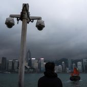 Surveillance cameras are seen as a visitor looks at Victoria Harbour in Hong Kong, Monday, March 11, 2024. The president of U.S.-funded Radio Free Asia said its Hong Kong bureau has been closed because of safety concerns under a new national security law, deepening concerns about the city’s media freedoms. Bay Fang, the president of RFA, said in a statement Friday March 29, 2024 that it will no longer have full-time staff in Hong Kong, although it would retain its official media registration. (AP Photo/Louise Delmotte, File)