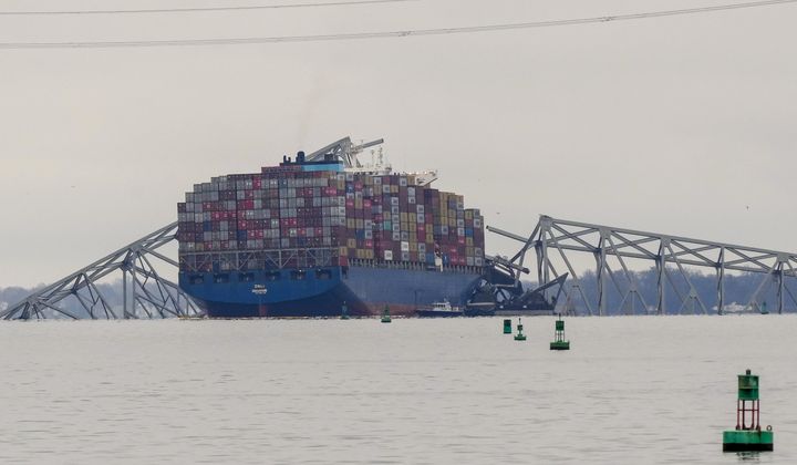 A container ship rests against wreckage of the Francis Scott Key Bridge on Wednesday, March 27, 2024, in Baltimore, Md. The ship rammed into the major bridge early Tuesday, causing it to collapse in a matter of seconds and creating a terrifying scene as several vehicles plunged into the chilly river below. (AP Photo/Matt Rourke)