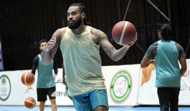 Isaac Banks, an American basketball player with the Hashed al-Shaabi - the Popular Mobilization Forces - in the Iraqi Basketball Super League, takes part in a team practice in Baghdad, Iraq, Thursday, March 21, 2024. U.S. players are in high demand on Iraqi basketball teams, even those whose owners have a tense relationship with Washington. (AP Photo/Hadi Mizban)
