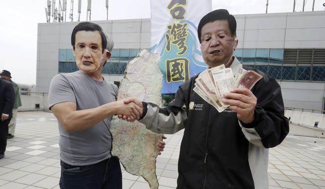 Protesters wearing masks of former Taiwanese President Ma Ying-jeou, left, and Chinese President Xi Jinping, right, perform, as Ma leaves for China outside of Taoyuan International Airport in Taoyuan City, Northern Taiwan, Monday, April 1, 2024. (AP Photo/Chiang Ying-ying)
