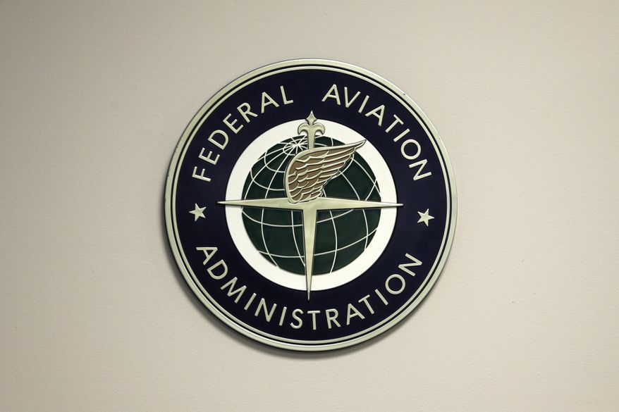 A Federal Aviation Administration sign hangs in the tower at John F. Kennedy International Airport in New York, March 16, 2017. (AP Photo/Seth Wenig, File)