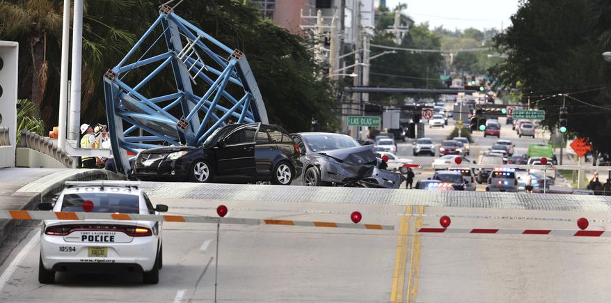 A construction worker was killed and two people were taken to the hospital after a portion of a crane dropped onto the Southeast Third Avenue bridge over the New River in downtown Fort Lauderdale, Fla., Thursday afternoon, April 4, 2024. (Carline Jean/South Florida Sun-Sentinel via AP)