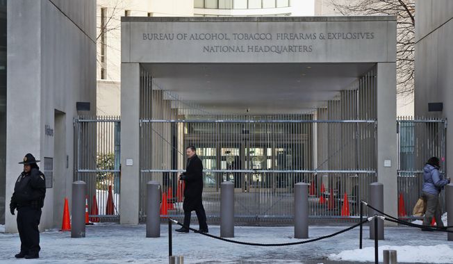 A security official walks in front of the entrance to the national headquarters of the Bureau of Alcohol, Tobacco, Firearms and Explosives on Jan. 23, 2014, in Washington. New data from the bureau shows that 68,000 illegally trafficked firearms in the U.S. came through unlicensed dealers who aren&#x27;t required to perform background checks over a five year report that was released Thursday, April 4, 2024. (AP Photo/Charles Dharapak, File)