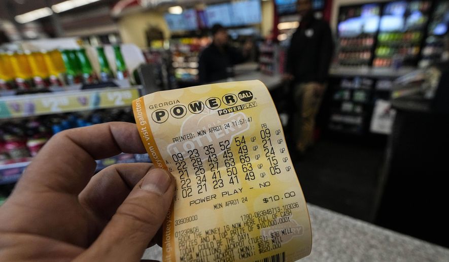 FILE - A Powerball lottery ticket is seen inside a convenience store, Monday, April 1, 2024, in Kennesaw, Ga. Powerball will match a record for lottery losing Saturday night, April 6, with a stretch of more than three months without a jackpot winner. (AP Photo/Mike Stewart, FIle)