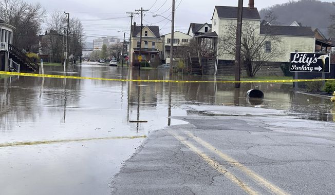 South York Street on Wheeling Island is closed to traffic as the Ohio River floods its banks, Thursday, April 4, 2024, in Wheeling, W.Va., following days of heavy rains in the region. (John McCabe/The Intelligencer via AP)