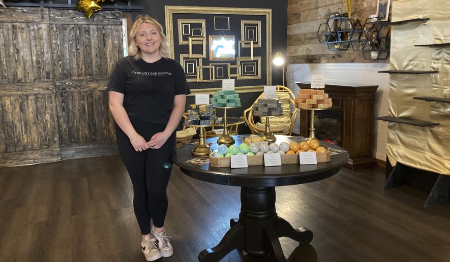 Kalee Hume stands alongside her handmade eclipse-themed soaps at her shop in downtown Waxahachie, Texas, on Saturday, April 6, 2024. Waxahachie will be in the path of totality for Monday's eclipse of the sun. (AP Photo/Marcia Dunn)