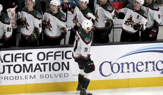 Arizona Coyotes right wing Dylan Guenther (11) is congratulated by the team bench after a goal in the third period of an NHL hockey game against the San Jose Sharks in San Jose, Calif., Sunday, April 7, 2024. (AP Photo/Scot Tucker)