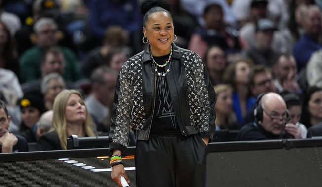 South Carolina head coach Dawn Staley watches from the bench during the second half of a Final Four college basketball game against North Carolina State in the women&#x27;s NCAA Tournament, Friday, April 5, 2024, in Cleveland. (AP Photo/Carolyn Kaster)