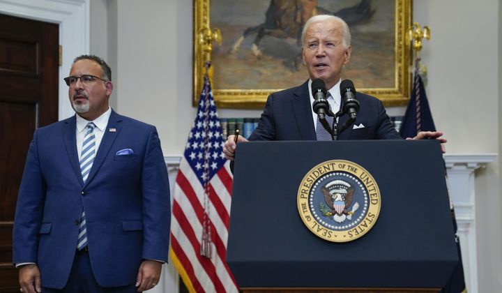 President Joe Biden speaks as Education Secretary Miguel Cardona listens at the White House, June 30, 2023, in Washington. (AP Photo/Evan Vucci) ** FILE **